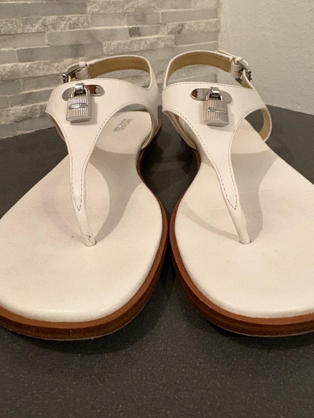 Michael Kors white leather sandals with silver-tone padlock charms. - Picture 2 of 5